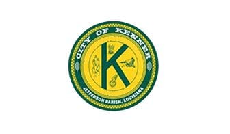 A green and yellow seal with the city of kenner in the center.